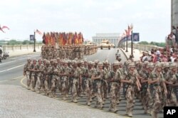 FILE - Troops march over the Memorial Bridge in Washington, D.C., as they head towards the Pentagon during the National Victory Day Parade on Saturday, June 8, 1991.