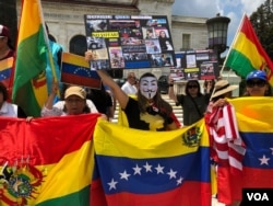 Venezuelan expats are joined by Nicaraguans, Bolivians and others during a protest calling for freedom and democracy in Venezuela, in front of the building of the Organization of American States, in Washington, May 20, 2018.