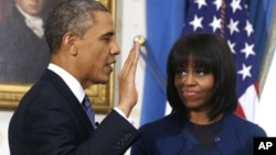 FILE - President Barack Obama is officially sworn-in by Chief Justice John Roberts in the Blue Room of the White House, Jan. 20, 2013.