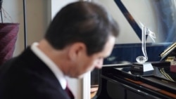 Musician David Shenton performs inside his home in the Queens borough of New York on March 30, 2021.