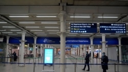 Eurostar staff stands in an almost deserted International Departures hall at St Pancras International station in London on December 21, 2020, after all services to Europe were cancelled as a string of countries banned travellers arriving from the UK, due