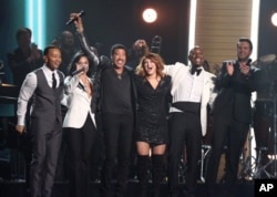 John Legend, from left, Demi Lovato, Lionel Richie, Meghan Trainor, Tyrese, and Luke Bryan perform a tribute to MusiCares Person of the Year honoree Lionel Richie at the 58th annual Grammy Awards, Feb. 15, 2016, in Los Angeles.