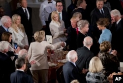 Newly sworn in President Donald Trump with his wife first lady Melania Trump, shakes hands with Hillary Clinton, as they arrive for the inaugural luncheon at the Statuary Hall in the Capitol.