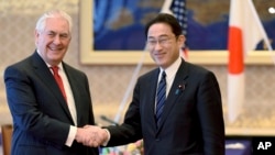U.S. Secretary of State Rex Tillerson is welcomed by his Japanese counterpart Fumio Kishida in Tokyo, March 16, 2017