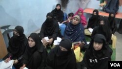 Children and adults attend class at the Street to School program in Karachi, Pakistan.