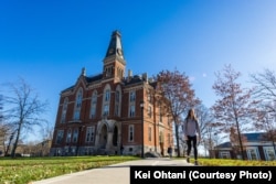 A student walks across the East Campus of DePauw University in Greencastle, Indiana.