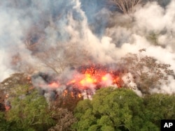 An image provided by the U.S. Geological Survey shows lava spattering from an area between active Fissures 16 and 20 at 8:20 a.m. HST, on lower east rift of the Kilauea volcano, near Pahoa, Hawaii, May 16, 2018.