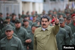 Venezuela's President Nicolas Maduro gestures during a meeting with soldiers at a military base in Caracas, Venezuela, Jan. 30, 2019.