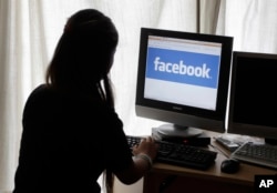 A young California woman takes a look at Facebook in this file photo.