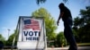 FILE - A voter leaves a polling site after casting a ballot in a special election in Marietta, Georgia, April 18, 2017.