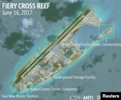 FILE: Construction is shown on Fiery Cross Reef in the Spratly Islands, the disputed South China Sea, in this June 16, 2017, satellite image released by CSIS to Reuters.