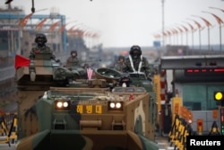 FILE - Amphibious assault vehicles of the South Korean Marine Corps travel during a military exercise as a part of the annual joint military training called Foal Eagle between South Korea and the U.S. in Pohang, South Korea, April 5, 2018.