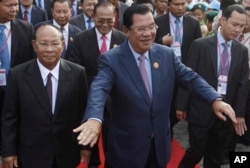 FILE-Cambodia's Prime Minister and President of the People's Party, Hun Sen, center, arrives at an event marking the 38th anniversary of the 1979 downfall of the Khmer Rouge regime in Phnom Penh, Cambodia, Saturday, Jan. 7, 2017. (AP Photo/Heng Sinith)