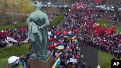 Supporters of former Georgian President Mikheil Saakashvili are gathering at the statue of Taras Shevchenko, a Ukrainian poet, writer, artist to march in protest of corruption in Ukraine in Kiev, Ukraine, Dec. 10, 2017.