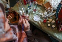Palestinian Hanan Al-Madhoon paints a glass as she makes decorations for sale ahead of the holy fasting month of Ramadan, at Beach refugee camp in Gaza City April 6, 2021. Picture taken April 6, 2021. REUTERS/Suhaib Salem