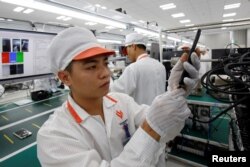 A manufacturer works at an assembly line of Vingroup's Vsmart phone in Hai Phong, Vietnam, Dec. 4, 2018.