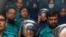 FILE - Journalists Shakil Ahmed, fifth from left, and Farzana Rupa, third from right, are pictured at a court in Dhaka, Aug. 22, 2024.