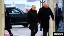 Russian President Vladimir Putin and Belarusian President Alexander Lukashenko arrive for meeting in Minsk