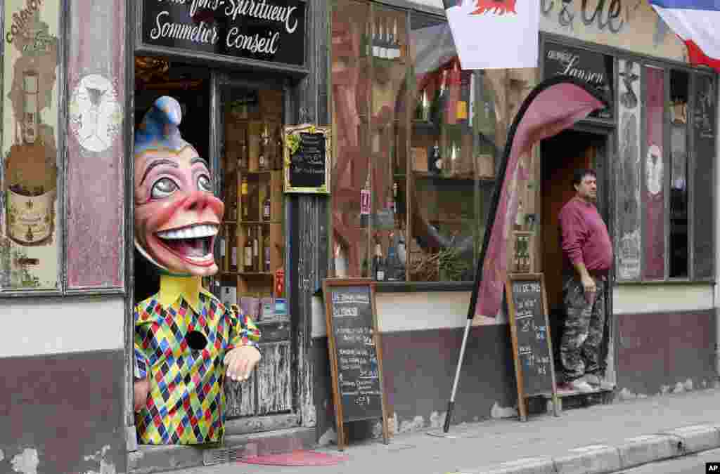 A 'Big Head' figure is displayed at the entrance of a wine shop during the 132nd Nice carnival in Nice, southeastern France.