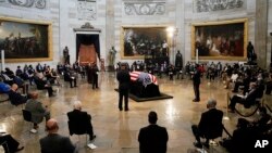 The flag-draped casket of the late Rep. John Lewis, D-Ga., a key figure in the civil rights movement and a 17-term congressman from Georgia, lies in state, Monday, July 27, 2020 at the Capitol in Washington. 