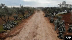 An aerial view shows Turkish soldiers gathering in the village of Qaminas, about 6 kilometres southeast of Idlib city in northwestern Syria on February 10, 2020. 