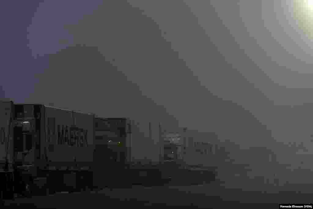 Trucks carrying vital humanitarian aid line up on the main road to the Rafah crossing amid harsh weather conditions. On the other side of the border, officials say as many as 14,000 Palestinians, including 2,500 children, require urgent medical evacuation. Rafah, Egypt, Feb. 4, 2025.