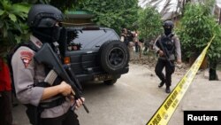 Anti-terror policemen hold rifles at house where a suspected supporter of Islamic State stays at Sepatan village in Tangerang, Indonesia's Banten province, Oct. 20, 2016, in this picture taken by Antara Foto. 