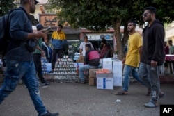 Palestinians sell items received in international aid shipments in an effort to collect cash in Deir al-Balah, Gaza, Nov. 13, 2024.