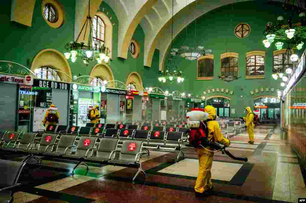 Servicemen of Russia's Emergencies Ministry wearing protective gear disinfect Moscow's Kazansky railway station, as the country adopts measures to curb the spread of the COVID-19. 