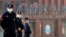 FILE - Security personnel keep watch outside the Wuhan Institute of Virology in Wuhan, Hubei province, China, Feb. 3, 2021.