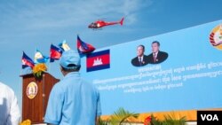 រូបឯកសារ៖ ឧទ្ធម្ភាចក្រ​ពណ៍ក្រហម​មួយ​គ្រឿង​​ ដែល​មាន​បិទ​ស្លាក​សញ្ញា​របស់​គណបក្សប្រជាជន​កម្ពុជា​ ហោះឆ្វែល​ ជុំវិញក្បួន​ដង្ហែ​គណបក្ស​ប្រជាជន​កម្ពុជា​ដើម្បី​ថត​យក​រូបភាព​នៃក្បួនដង្ហែនេះ​ នៅ​ភ្នំពេញ​ថ្ងៃ​ទី​ ០២ ខែ​មិថុនា ឆ្នាំ២០១៧។ (ខាន់​ សុគុំមនោ/វីអូអេ)