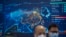 FILE - Visitors wearing face masks stand near a display showing an electronic map of China at the PT Expo in Beijing, June 4, 2023. The annual expo showcases Chinese and foreign technology firms.