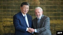 FILE - China's President Xi Jinping shakes hands with Brazil's President Luiz Inacio Lula da Silva after a meeting at Alvorada Palace in Brasilia on Nov. 20, 2024.