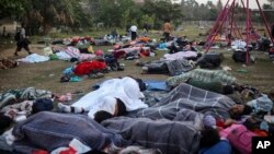 Dozens of Central American migrants, traveling with the annual "Stations of the Cross" caravan, sleep at a sports club in Matias Romero, Oaxaca State, Mexico, April 3, 2018. The caravan of Central American migrants that angered U.S. President Donald Trump was sidelined at a sports field in southern Mexico with no means of reaching the border even as Trump tweeted another threat to Mexico Tuesday. (AP Photo/Felix Marquez)