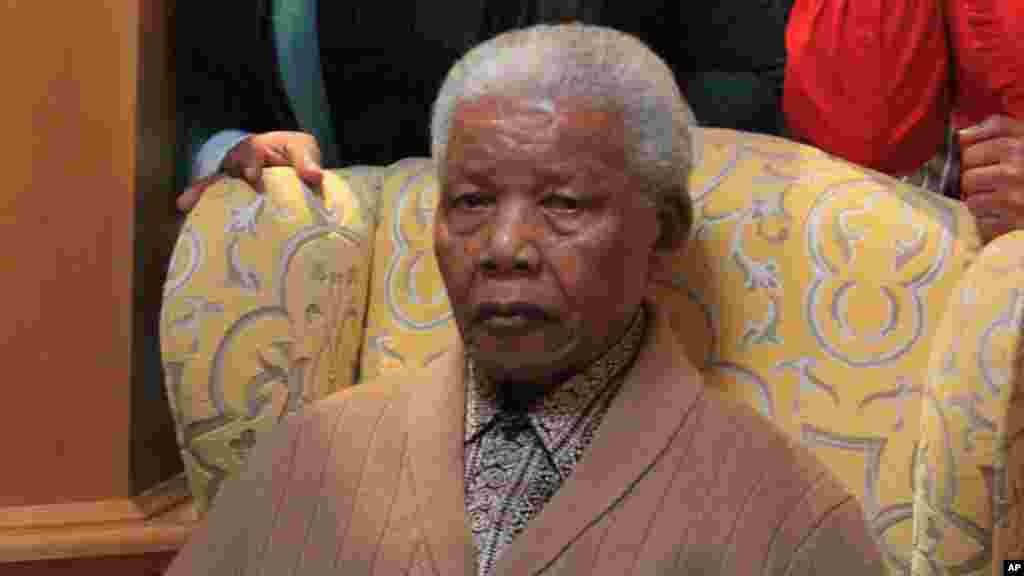 Mandela poses for a photograph after receiving a torch to celebrate the African National Congress' centenary&nbsp; in his home village, Qunu, in rural eastern South Africa, May 30, 2012.