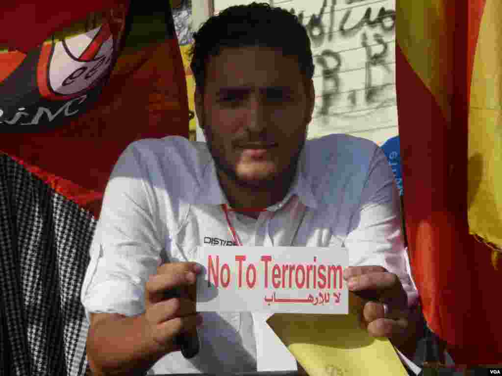 A man in Tahrir Square&nbsp;holds a sticker saying "No To Terrorism" in reference to the Muslim Brotherhood, July 7, 2013. (S. Behn/VOA)