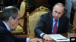 FILE - Russian President Vladimir Putin, right, listens to Russian Foreign Minister Sergey Lavrov during their meeting in the Kremlin in Moscow, Russia, March 14, 2016. 