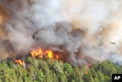 FILE - In this image released by the Ontario Ministry of Natural Resources and Forestry, the Sudbury 17 wildfire burns east of Mississagi Provincial Park near Elliot Lake, Ontario, on June 4, 2023.(Ontario Ministry of Natural Resources and Forestry/The Canadian Press via AP, File)