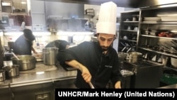 Chef Nadeem Khadem Al Jamie, a Syrian refugee, works in the kitchen of the Hotel d'Angleterre for the Refugee Food Festival, Oct. 11, 2017.
