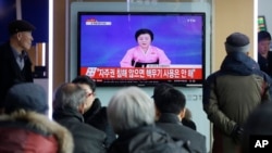 People watch a TV news program showing North Korea's announcement, at the Seoul Railway Station in Seoul, South Korea, Wednesday, Jan. 6, 2016. 