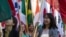 FILE - International students carry their national flags at the University of Missouri in Columbia, Mo.