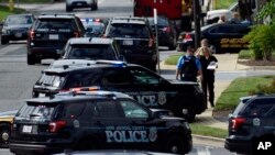 Police secure the scene of a shooting at the building housing The Capital Gazette, a newspaper in Annapolis, Md., June 28, 2018. 