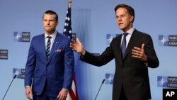 NATO Secretary General Mark Rutte, right, and United States Secretary of Defense Pete Hegseth address a media conference during a meeting of NATO defense ministers at NATO headquarters in Brussels, Feb. 13, 2025.