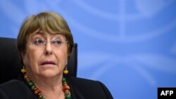 (FILES) In this file photograph taken on December 9, 2020, UN High Commissioner for Human Rights Michelle Bachelet looks on as she attends a press conference in Geneva. - The UN rights chief warned April 13, 2021, of possible crimes against humanity in My