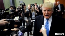 U.S. Republican presidential candidate Donald Trump answers questions from the media ahead of a campaign stop in Spencer, Iowa Dec. 5, 2015. 