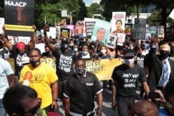 People gather for a civil rights National Association for the Advancement of Colored People (NAACP) protest march, June 15, 2020 in Atlanta, Georgia.