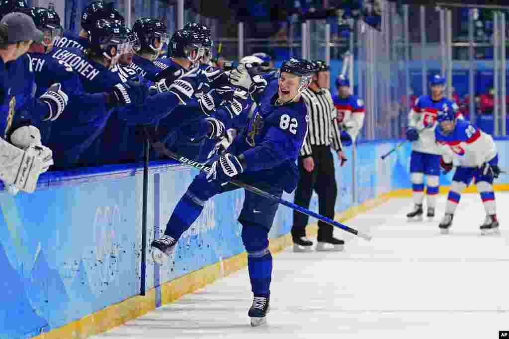 Finland's Harri Pesonen (82) celebrates after scoring a goal against Slovakia during a men's semifinal hockey game at the 2022 Winter Olympics, in Beijing. Finland won 2-0. 