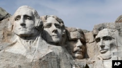 FILE - This March 22, 2019, file photo shows Mount Rushmore in Keystone, S.D. President Donald Trump will begin his Independence Day weekend on Friday with a patriotic display of fireworks at Mount Rushmore National Memorial before a crowd of…