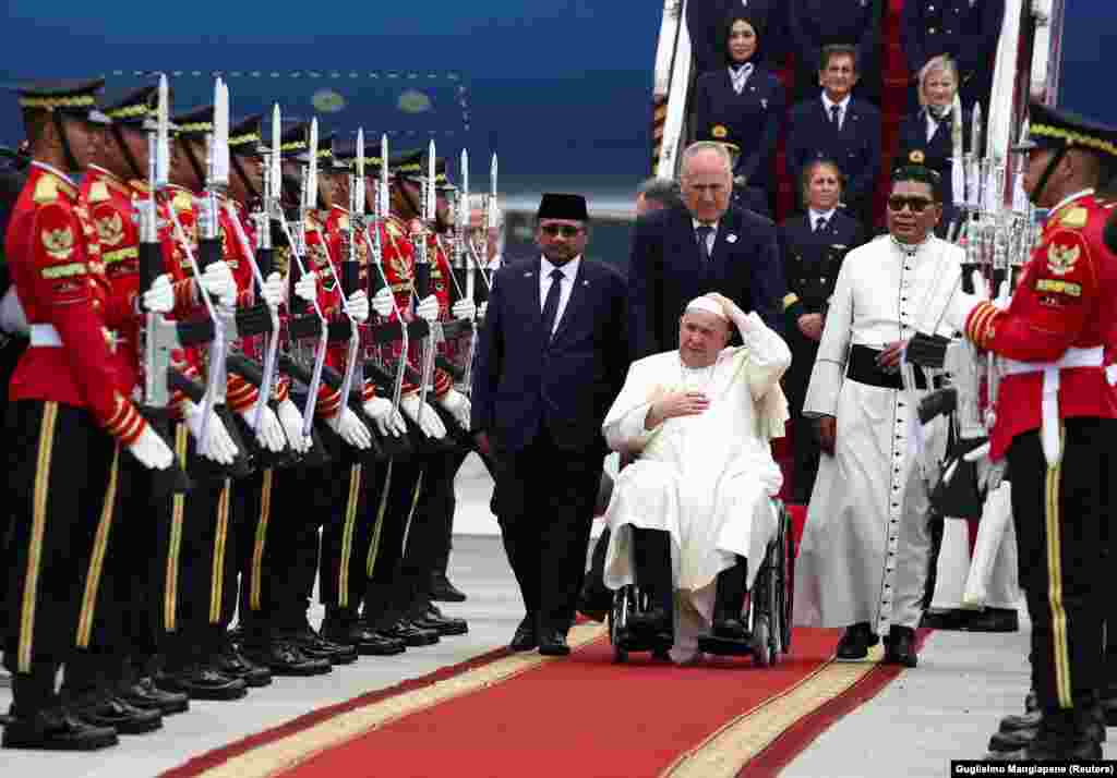 Indonesia's religious affairs minister Yaqut Cholil Qoumas welcomes Pope Francis at Soekarno-Hatta International Airport, in Tangerang near Jakarta.