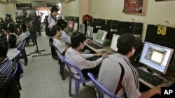 FILE - Students surf web at an Internet cafe in Hanoi, Vietnam, March 31, 2010. 